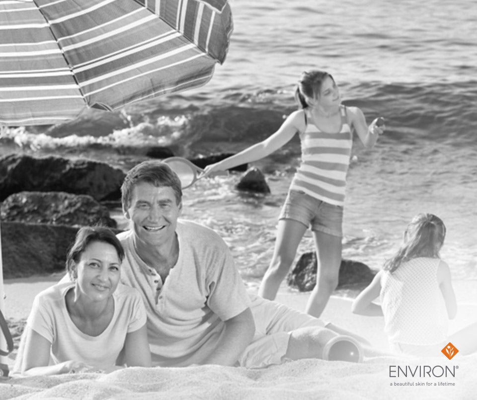 Black-and-white striped beach umbrella providing sun protection in article about undoing sun damage