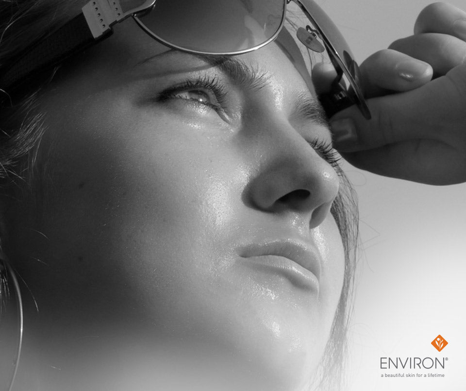 Black-framed sunglasses with sleek modern design ideal for protecting eyes and enhancing radiant summer skin tips