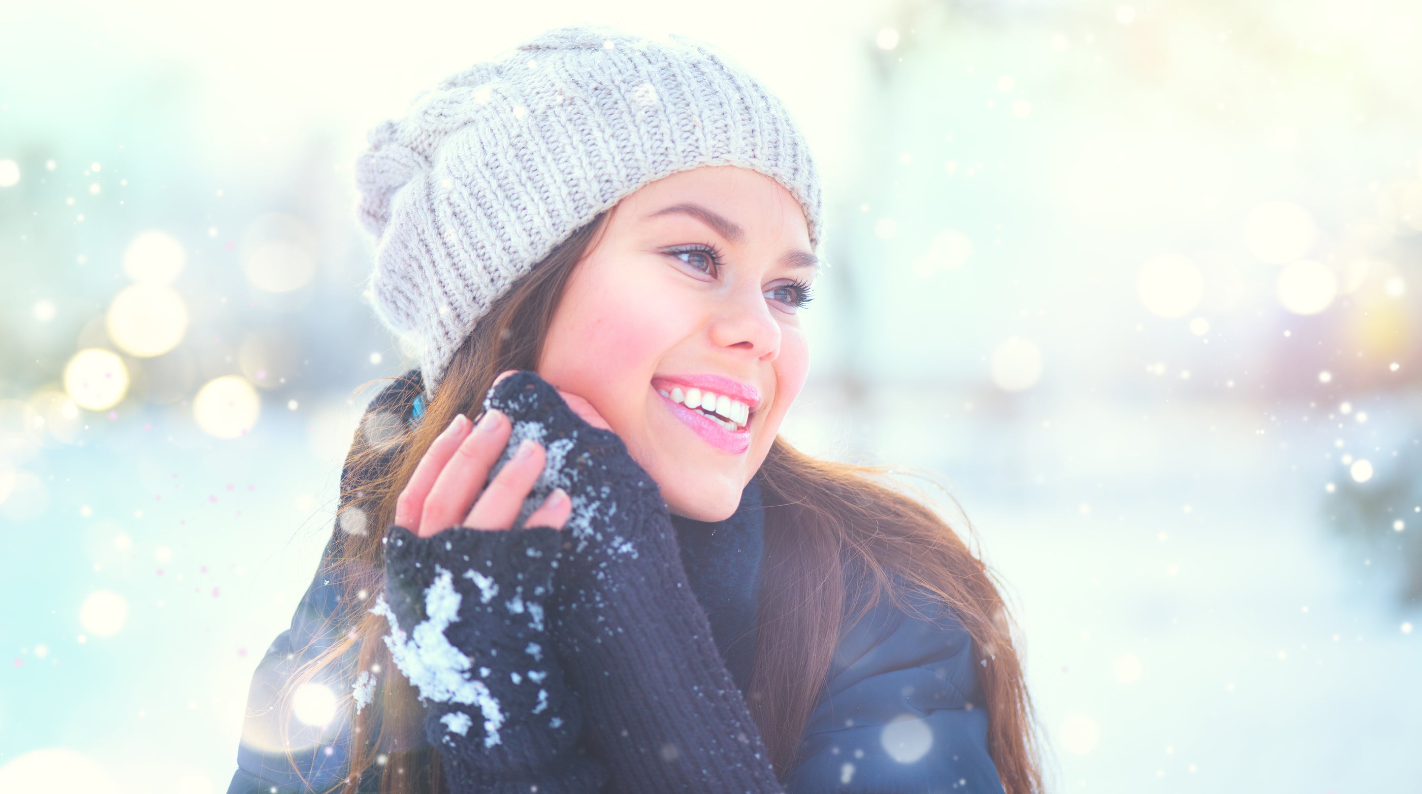A cozy light gray knitted beanie with soft texture and ribbed pattern perfect for winter skin care outdoors