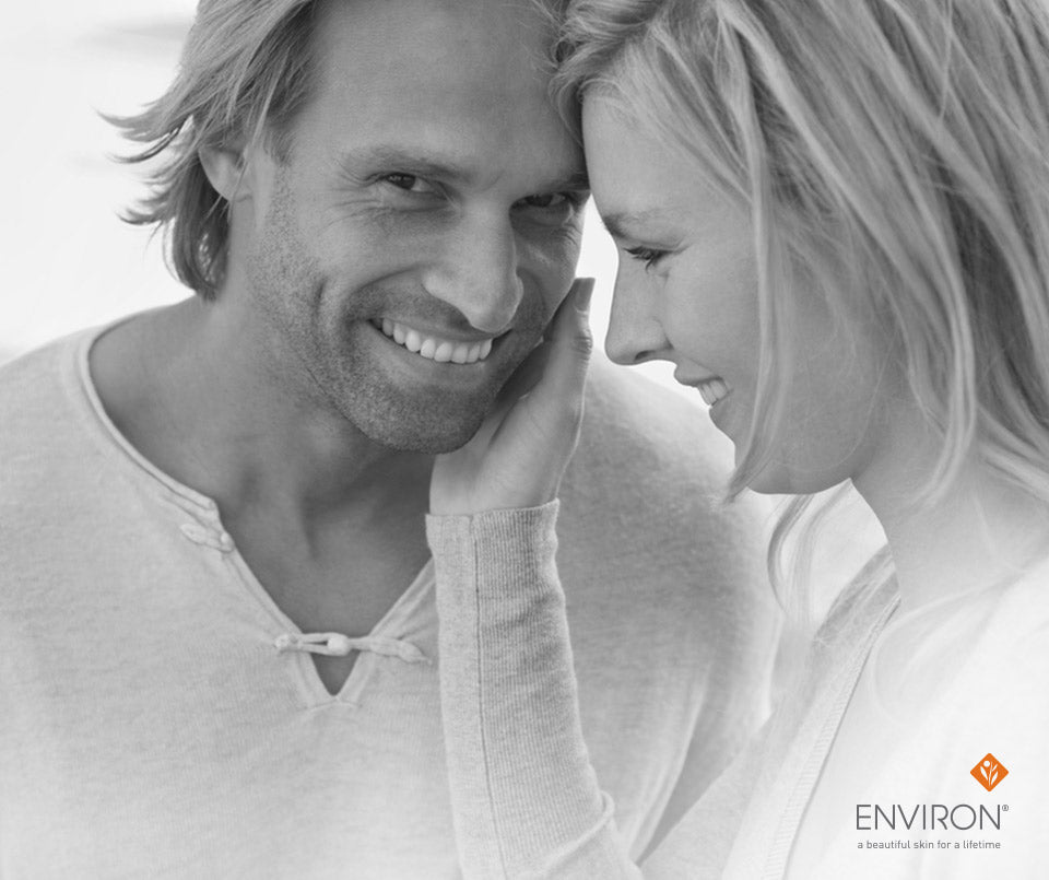 Black-and-white ad with smiling man and woman beside environ logo in an article about silky-smooth skin savers