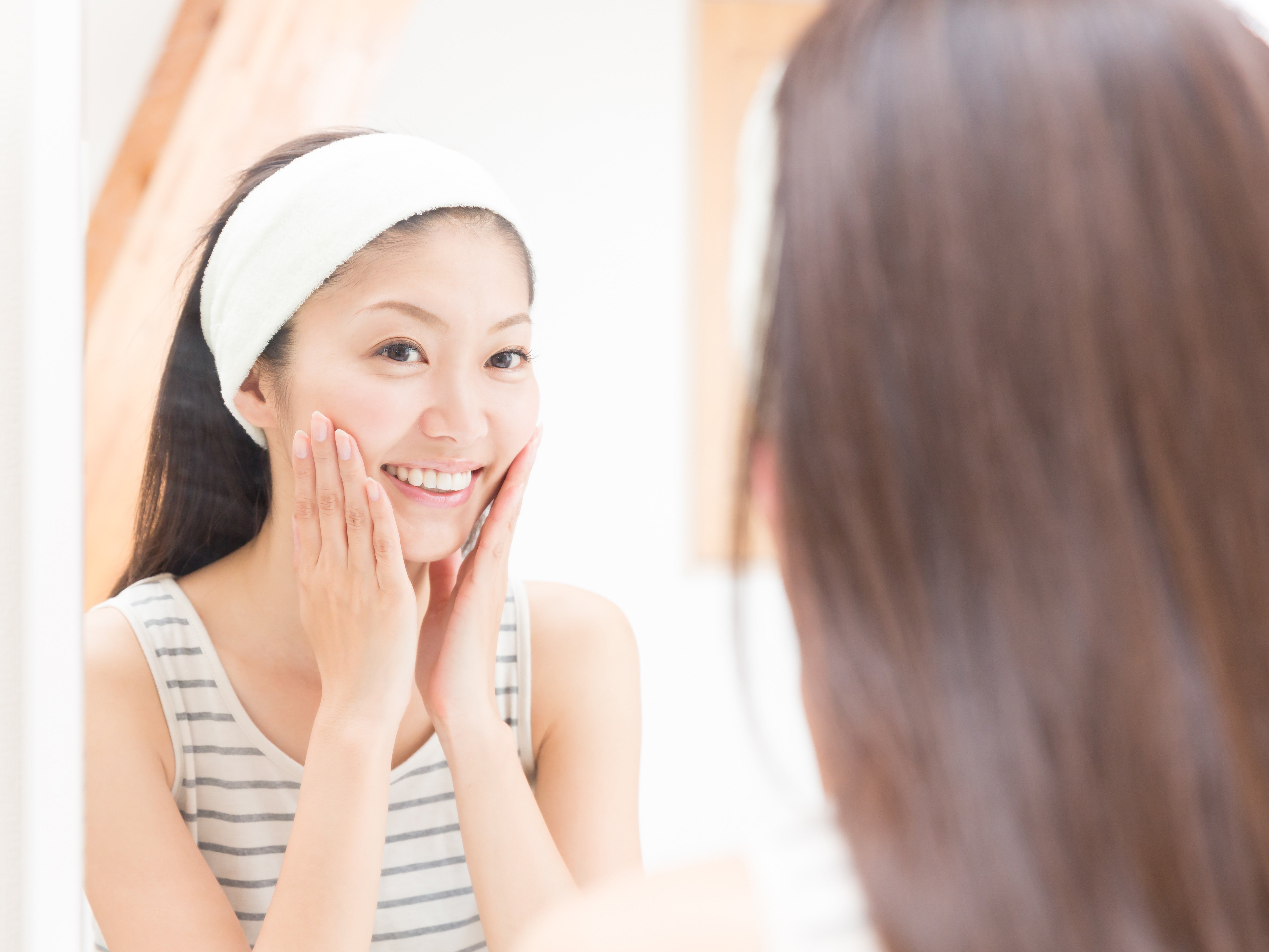 Woman wearing a white fabric headband for diy exfoliation skin care secrets article