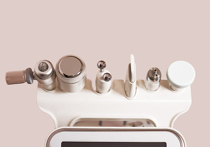 A sleek white skincare device with metallic and translucent attachments arranged neatly for smart purchasing decisions