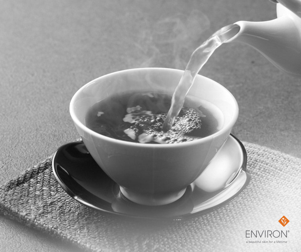White ceramic teacup with saucer filled with steaming tea being poured, ideal for waistline and health benefits