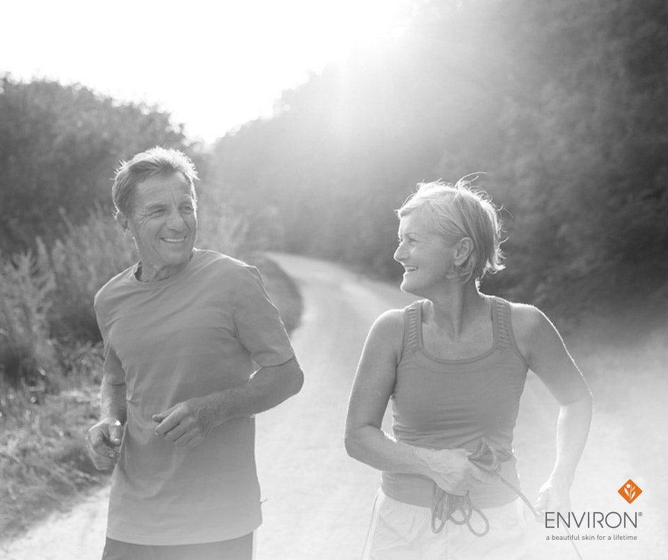 Black and white advertisement of a smiling older couple jogging outdoors promoting environ for a longer life
