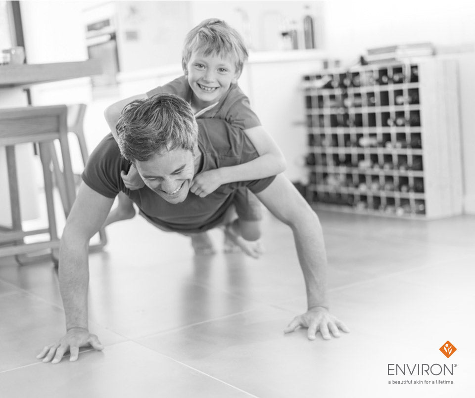 Black-and-white photograph of a man and child engaging in playful physical activity for better health tips