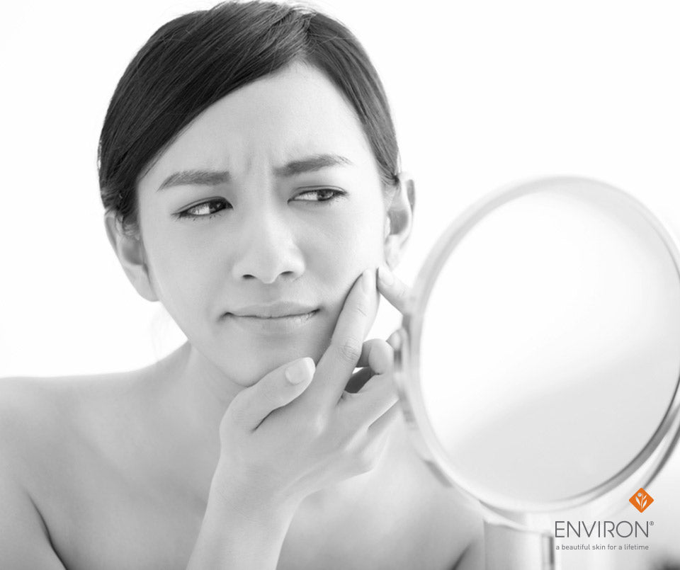 Round hand-held mirror with metallic frame and reflective surface for problem skin solutions with the b-active range