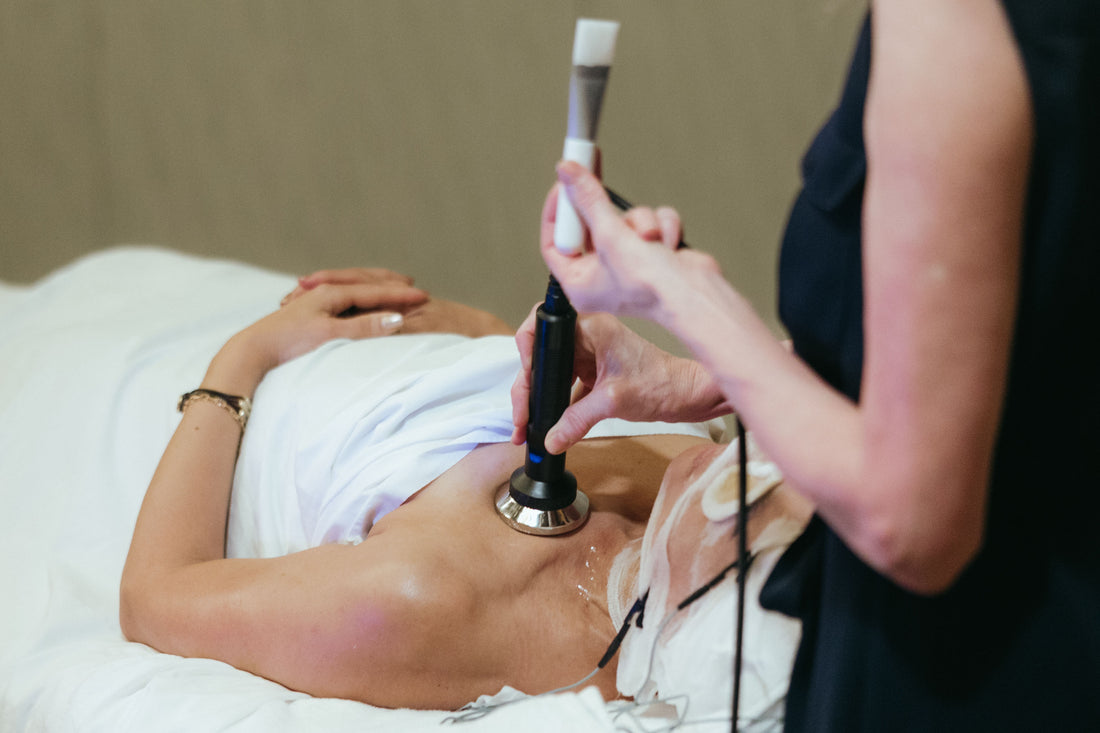 Black and silver handheld ultrasound device with circular transducer head used in DF Technology medical imaging
