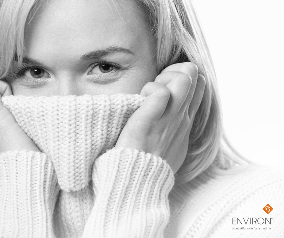 White knitted scarf with ribbed texture worn around the face to help give dry winter skin the boot