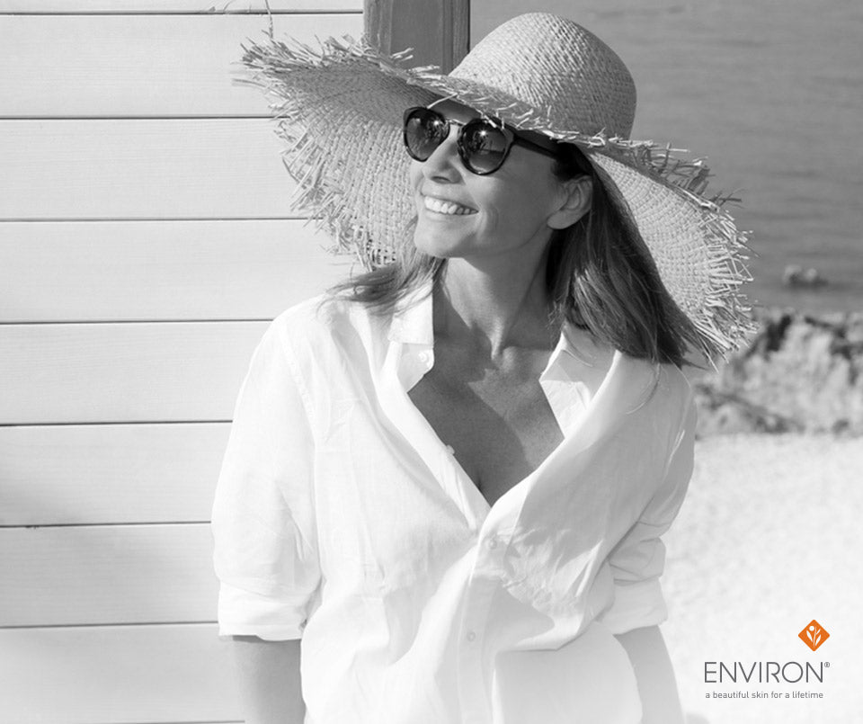 Wide-brimmed straw hat with frayed edges perfect for sun protection and complementing glowing skin looks.