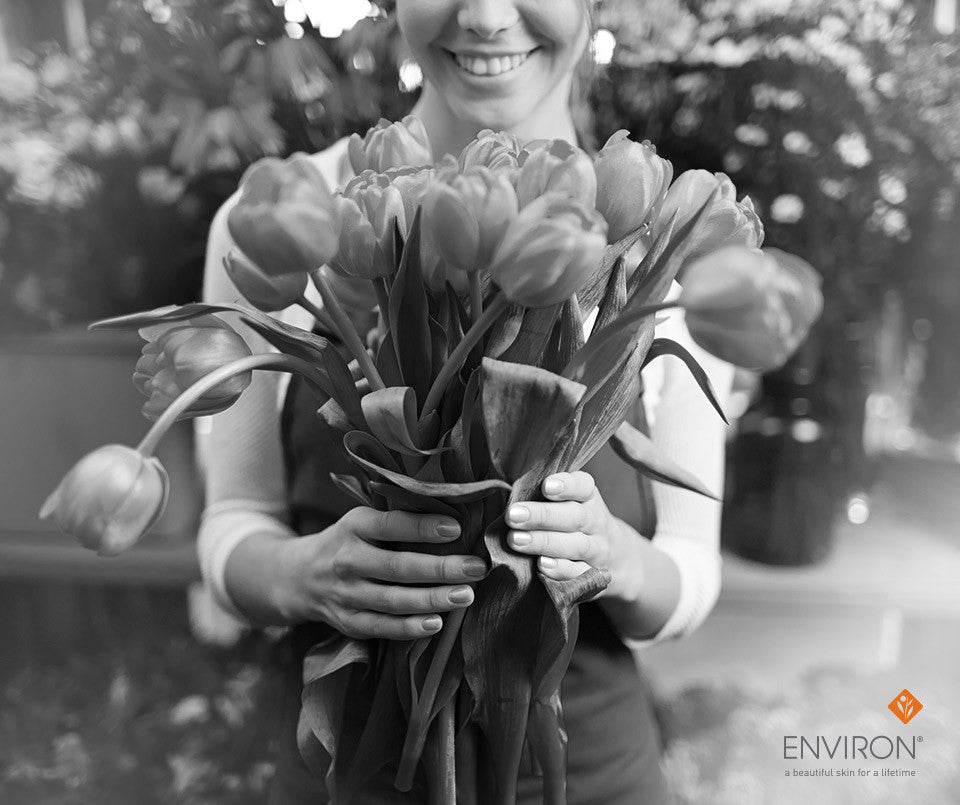 A bouquet of pink and yellow tulips with open and closed blooms held in hands for a sensational simple look