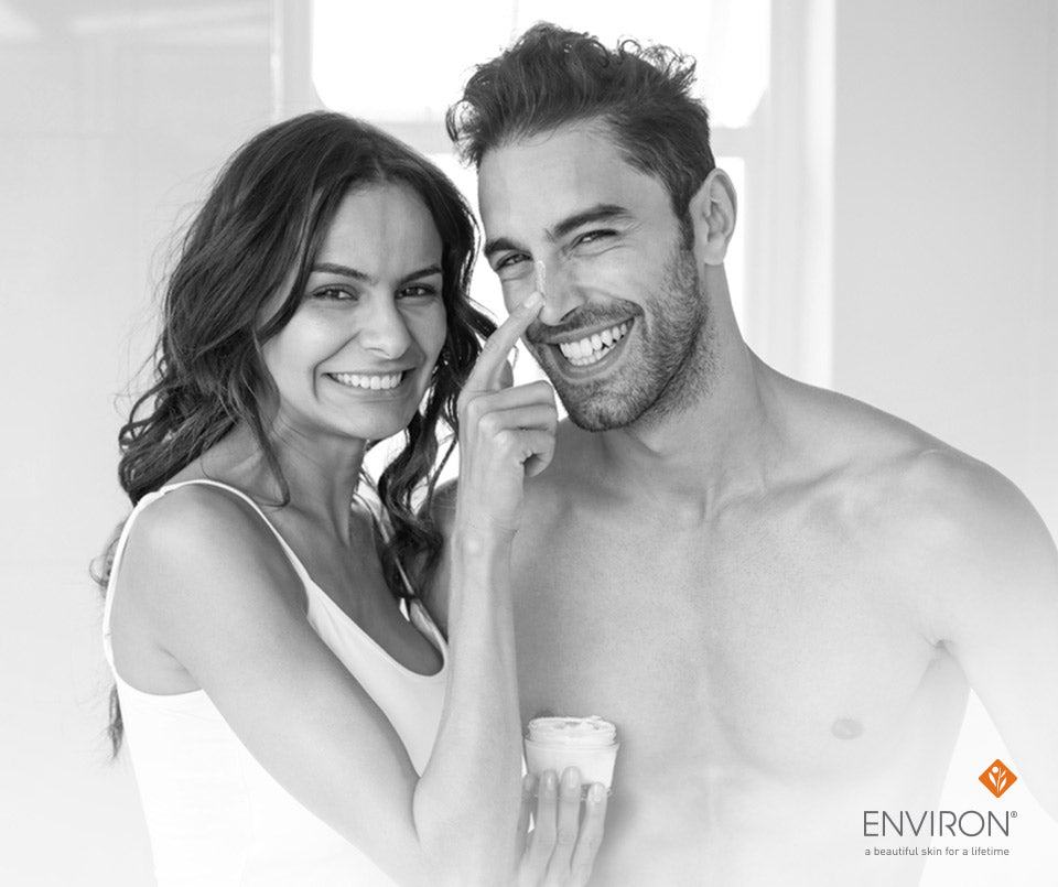 A small white cylindrical environ skincare jar held in a woman’s hand for skin boost kits designed for you.
