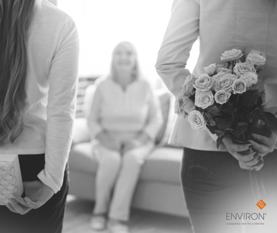 A bouquet of roses with delicate petals and dark green foliage held in hands as the perfect mother’s day gift