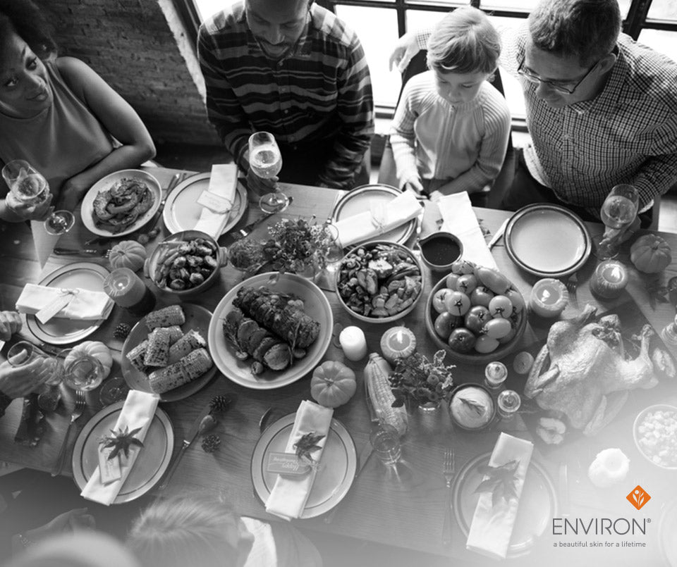 Black-and-white photograph of a family around a dining table with thanksgiving food highlighting health benefits