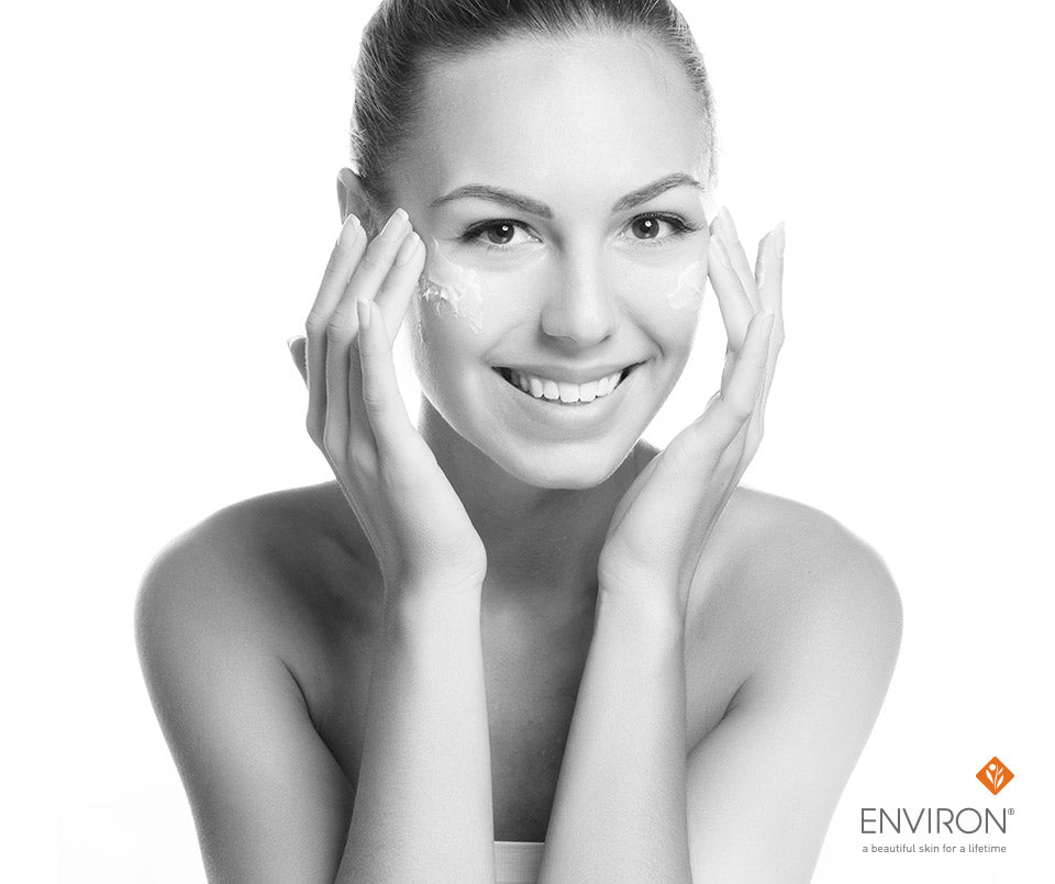 A woman applying creamy facial skincare product in black and white for a-mazing skin care routine