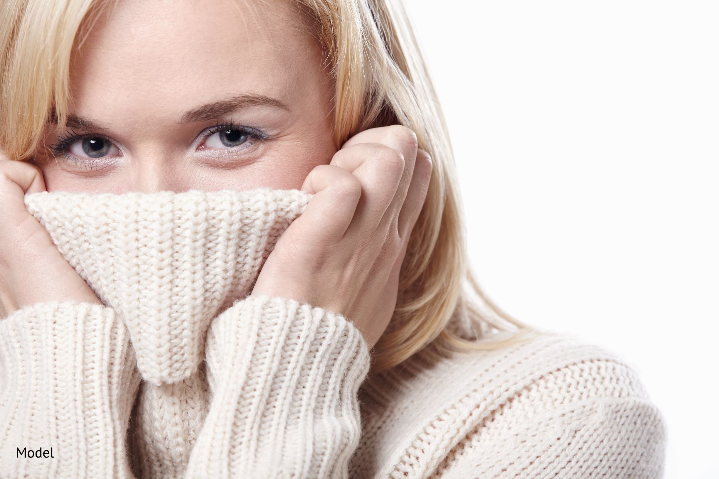 Cream-colored ribbed knit sweater with cozy textured pattern perfect for helping dehydrated winter skin stay warm