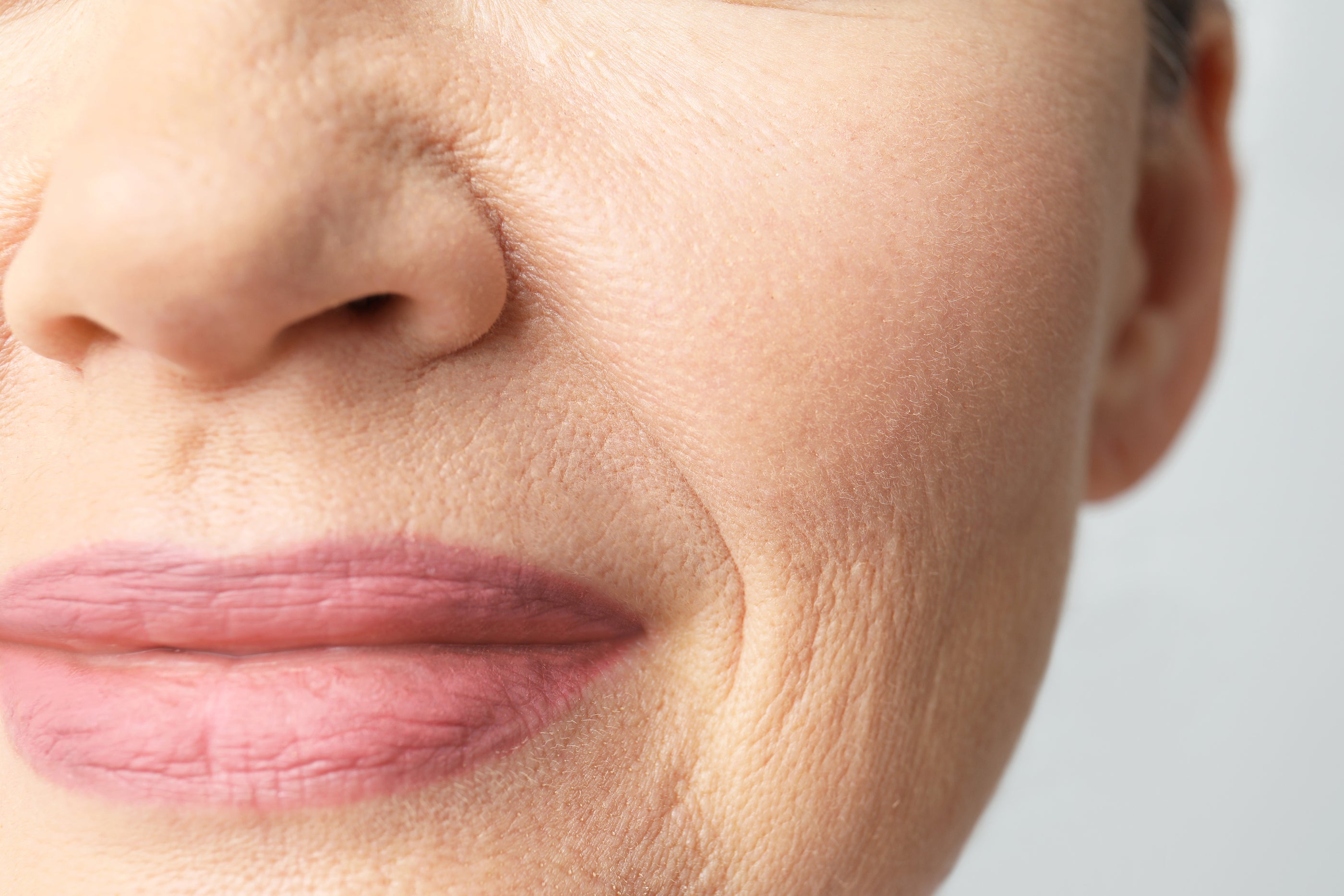 Soft pink lips with subtle texture and natural skin tones demonstrating how to reduce the look of lip lines.