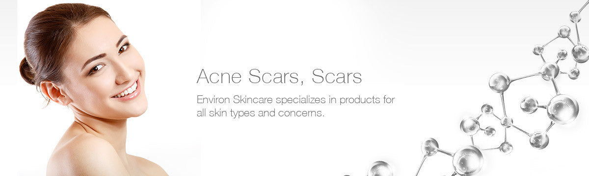 A smiling woman with clear skin and her hair in a bun promoting environ skincare acne scar treatment products.