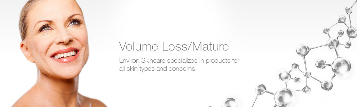 A smiling woman with fair skin and blonde hair wearing a subtle silver necklace in volume loss mature collection