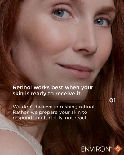 A woman with red hair and blue eyes wearing a white top.