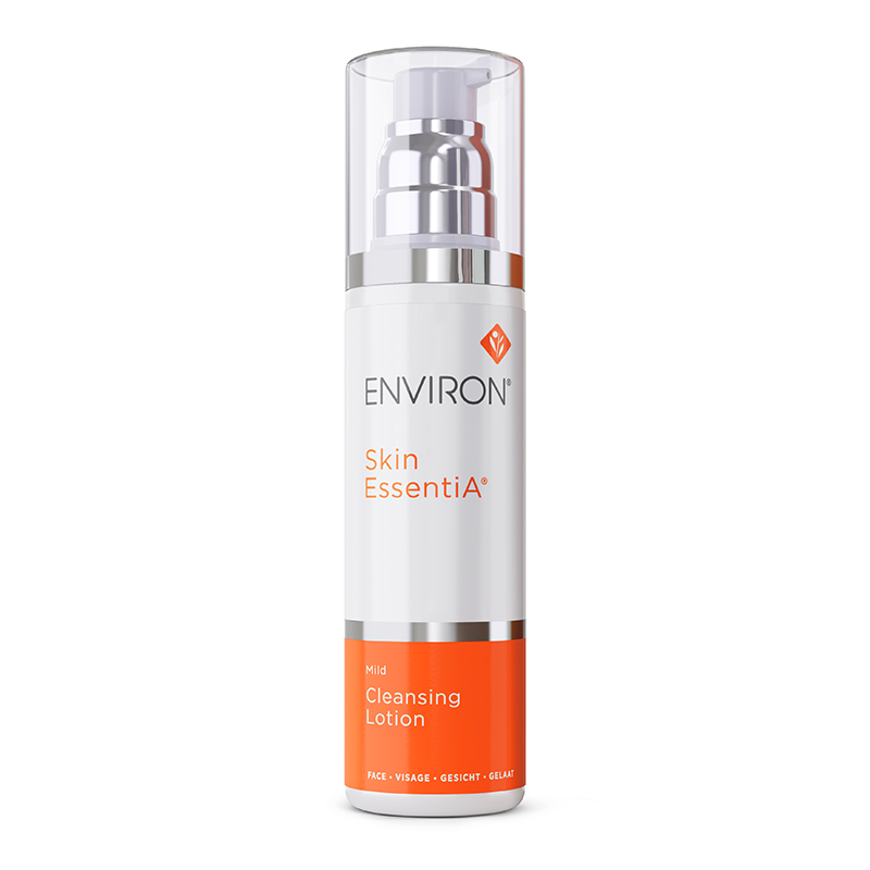 A white and orange bottle of Environ Skin EssentiA Mild Cleansing Lotion stands upright, featuring a pump dispenser and a clear cap.