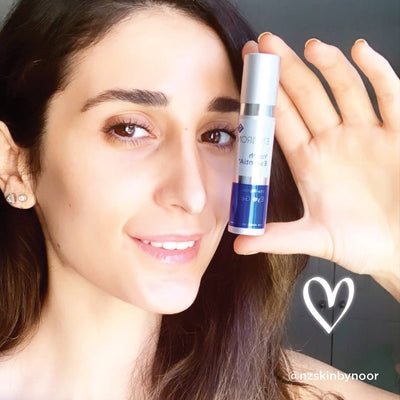 Silver and blue cylindrical skincare serum bottle with a white label featuring black text.