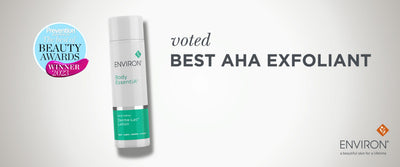 A sleek white and teal cylindrical bottle of environ body essentials derma-loci lotion, featuring a minimalist design with green branding accents.