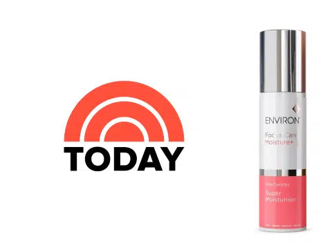 Silver and coral pink enviro+ face &amp; eye moisturizer bottle with a sleek metallic cap.