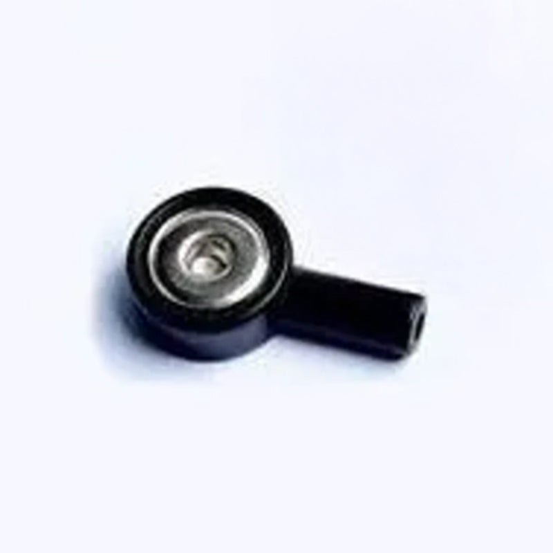 A small black plastic elbow connector featuring a central silver screw rests on a white surface.