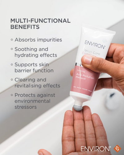 A white and pink environ anti-pollution masque tube with a silver band, held in hand above an open palm.