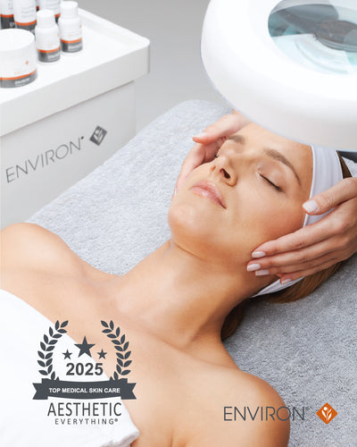 White environ medical skincare treatment lamp with a circular, translucent dome over the client’s face.