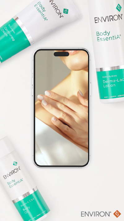 White and teal environ body essentia product tubes arranged around a smartphone screen displaying skin care imagery.
