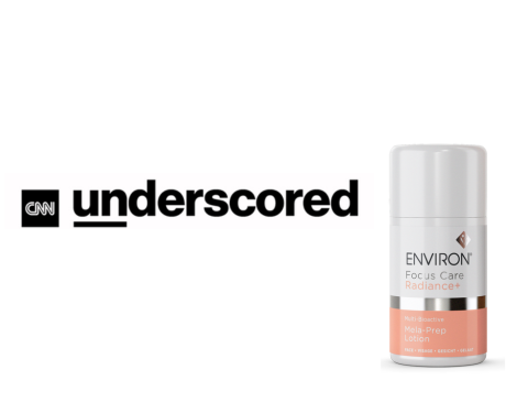 A sleek white and peach-colored environ focus care radiance moisturizing serum bottle with a silver band.