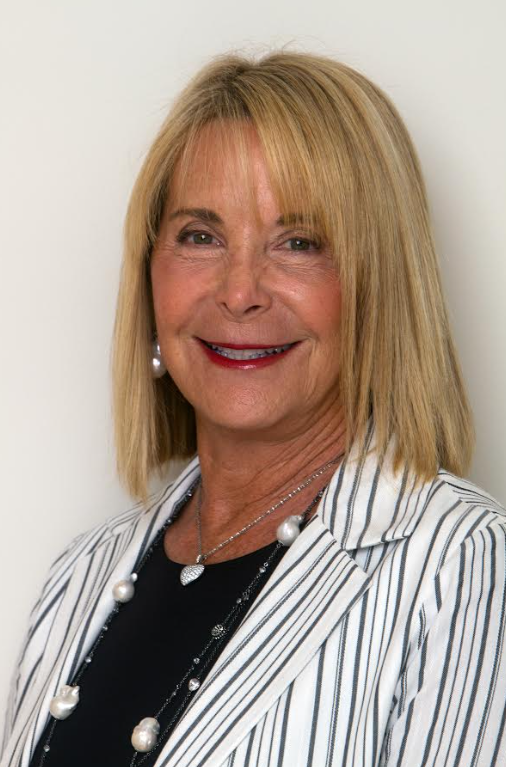 A woman wearing a black and white striped blazer over a black top.