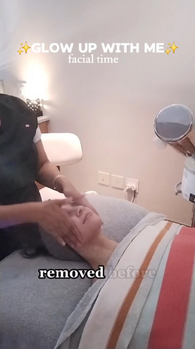 A person receiving a facial treatment with their face gently being worked on by a practitioner.