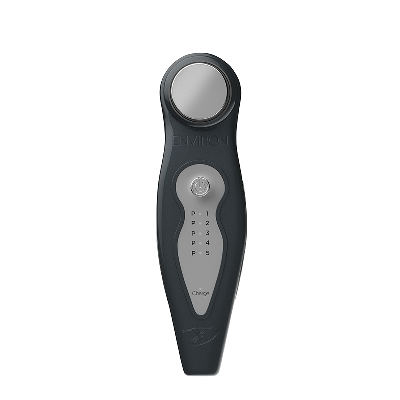 A sleek black Environ electro-sonic skincare device features a circular metallic treatment head and a digital control panel with five program settings.
