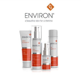 The image displays a collection of environ skincare products, including serums and creams in sleek white tubes with bold red accents.