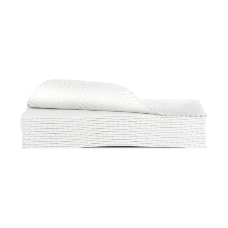 A stack of white textured paper guest towels sits neatly on a white background with the top sheet partially lifted.