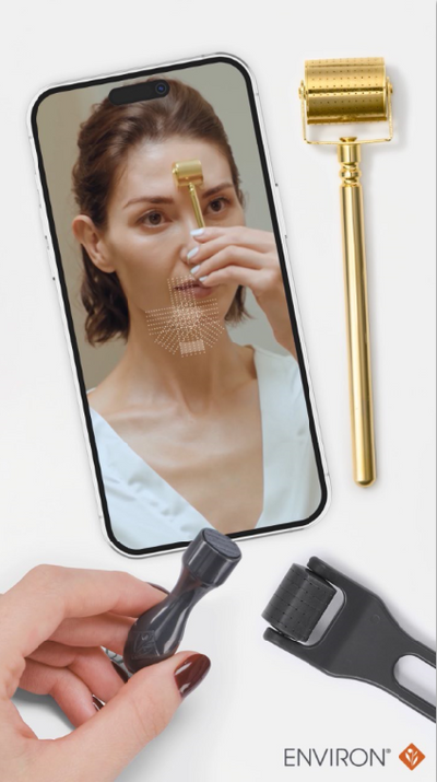 Gold roller device with a perforated cylindrical head and slender handle, alongside black interchangeable attachments for facial microdermabrasion use