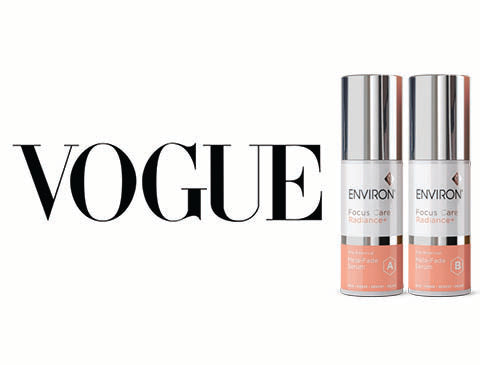 Two sleek, silver-topped cylindrical bottles with peach-colored bases and white labels featuring the ’environ’ brand name.