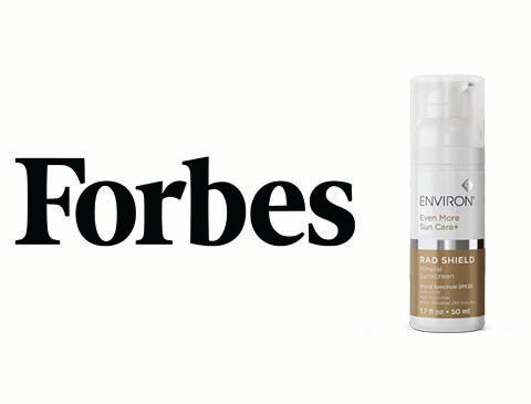 The envion even more sun care rad shield spf 50+ sunscreen in a sleek, transparent pump bottle with a brown label and white cap.
