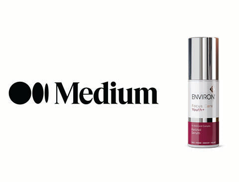 Silver and maroon environ focus+ youth anti-aging serum bottle with a sleek metallic cap