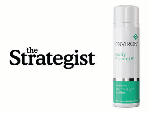 White cylindrical bottle with teal label and silver cap, featuring ’environ body essentia’ branding