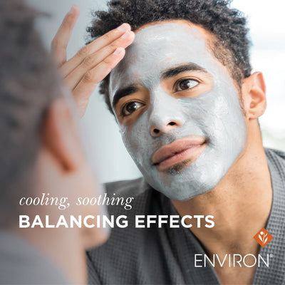 A man wearing a gray, textured facial mask with cooling and soothing balancing effects from environ.
