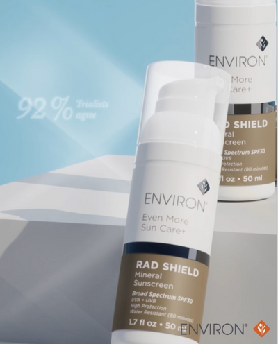 White and brown environ rad shield mineral sunscreen bottle with a white pump dispenser.