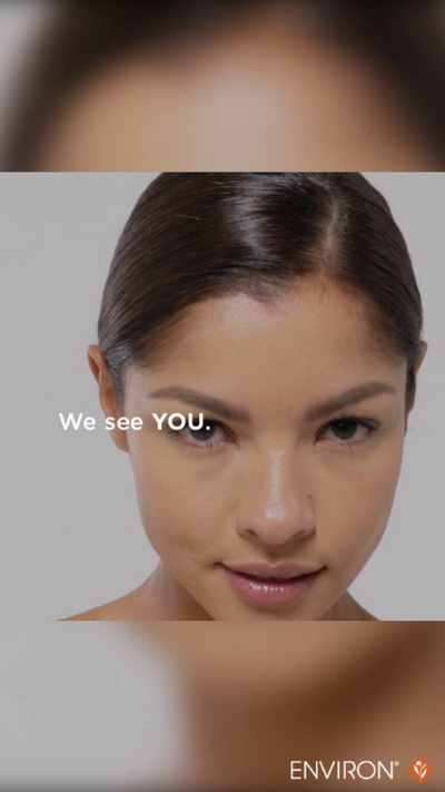 A close-up portrait of a woman with dark hair and subtle makeup, featuring the environ brand logo in the corner.