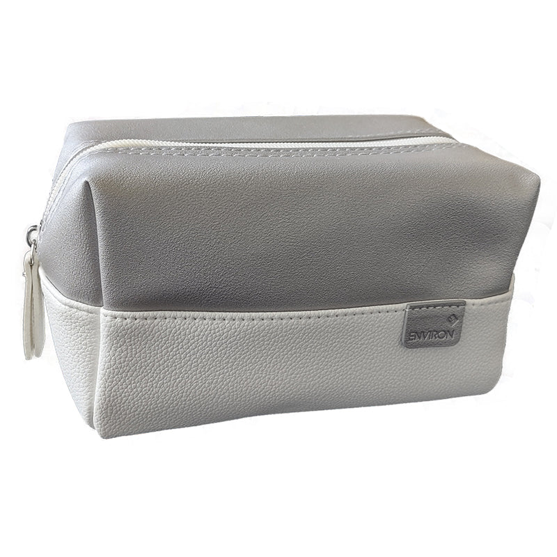 An elegant Environ cosmetic travel bag features a two-tone metallic gray and white textured faux-leather design with a top zipper.