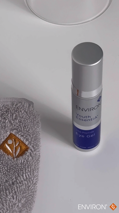Silver-topped, cylindrical environ youth essentials eye gel bottle with a blue label and white text.