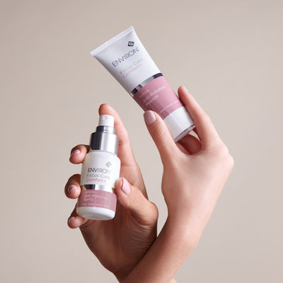 White and pink environ focus care comfort+ skincare products held in hands