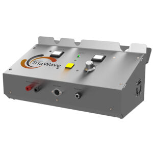 A TriaWave electronic therapy device features a brushed metal housing with a slanted control panel and multiple front-facing connection ports.