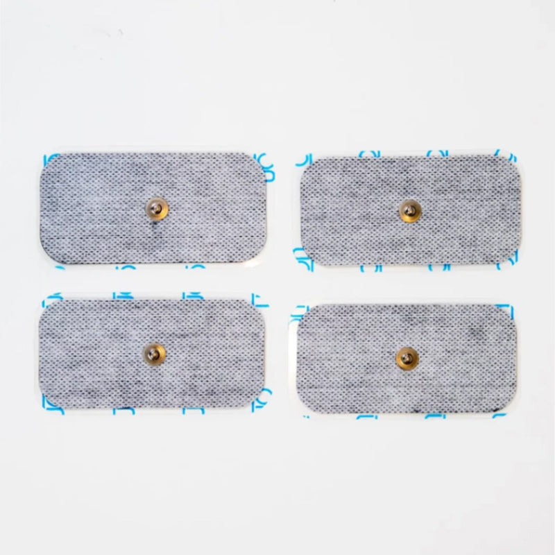 Four grey rectangular TENS unit electrode pads with brass snap connectors rest on a white background.
